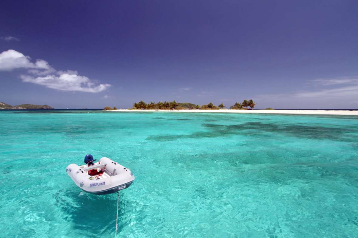 Our dingy, Junior, in front of Sandy Island