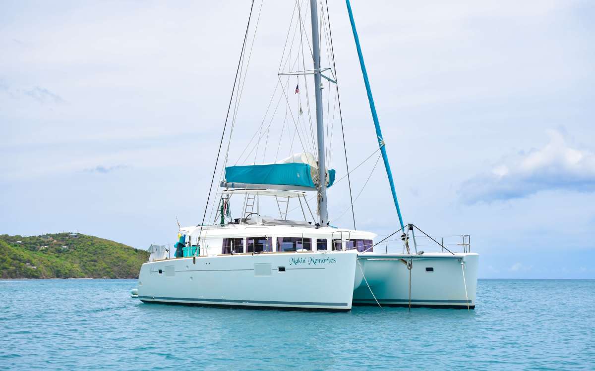 This 2016 Lagoon 450 offers an amazing amount of space for her size.  There are four beautifully appointed queen sized  staterooms with lots of light and storage space.  Each of the cabins have climate control and pristine ensuite bathrooms.  Throughout the yacht light wood is used and the decor is simple and contemporary.

The lounge area has comfortable seating and an indoor dining option - plus the signature Lagoon wraparound windows that offer a fantastic panoramic view.  The cockpit is shaded and has two distinct seating areas with lots of space to walk around comfortably - easy access through to the back steps for swimming.  The fly bridge is where the sailing action takes place, but is also the best spot for dolphin spotting or just taking in the amazing Virgin Island scenery. 

Forward there are trampolines and a great seating area. This new yacht is going to be a popular lady without a doubt!

 