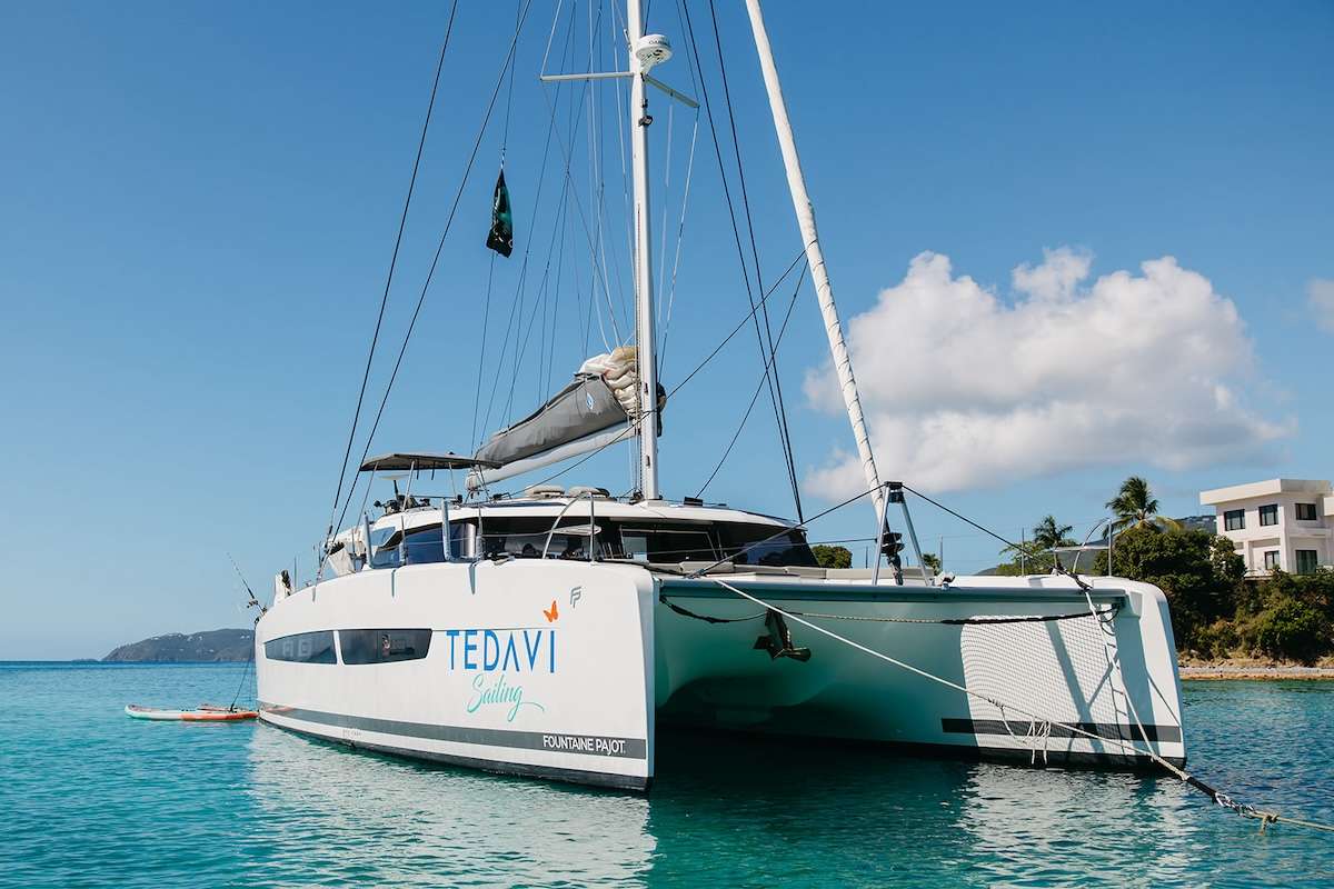 Introducing Tedavi, a brand new 2022 Fountaine Pajot Aura 51. Her sleek design seamlessly
combines fantastic sailing capabilities with luxurious and comfortable spaces for living and
relaxing.
A great new feature is the complete opening between the saloon and the cockpit,
an innovation which will offer you an even greater feeling of freedom and space. The galley
and saloon are modern and bright adding to the spacious feel of this newly designed 51 foot
catamaran.
The large table in the cockpit seats eight adults comfortably for al fresco dining,
playing some board games or enjoying a movie on the 60-inch projector screen.
She has a large flybridge offering 360 degree views with plenty of lounge seating and a
sunbathing area for all to enjoy. The foredeck is another spacious area with reclinable
seating and areas for relaxation. Both areas can be covered with sun shades, allowing you
to enjoy the ocean breeze while taking in the beauty of your natural surroundings in comfort.
Tedavi has four queen cabins, one of which is a spacious master cabin with an additional
entrance opening onto the aft deck for direct bed to ocean access. All cabins have en-suite
bathrooms with electric freshwater toilets, individually controlled air conditioning units,
multiple integrated USB ports and queen beds which face the ocean for the perfect view to
wake up to.
Tedavi means “healing” in Turkish and is the perfect name for this beautiful yacht on which
you can experience the healing power of sailing on a vacation unlike any other.