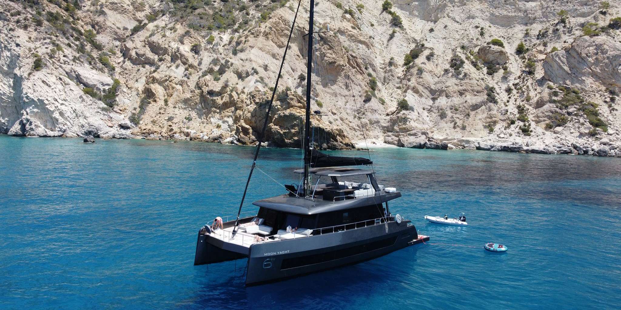 Step aboard FULL MOON, the first of the newly launched MOON 60 SAIL Gen. 2 series – a stunning blend of cutting-edge design and refined comfort. Delivered in August 2024 as the shipyard’s exclusive demo yacht, FULL MOON has graced only the most prestigious yacht shows.
Accommodating up to 10 guests in 5 beautifully appointed cabins – including a luxurious owner’s suite and a VIP cabin – FULL MOON is a haven of elegance and privacy. Each cabin features a private ensuite bathroom, while the separate crew quarters ensure premium service on board. The central galley is fitted with top-tier appliances, perfect for gourmet dining experiences.
From the teak-lined decks and expansive saloon with real glass windows, to the bespoke woodwork, quartz surfaces, and leather accents, every detail has been carefully considered. Plush sofas, luxury upholstery, and decorative elements create a warm and inviting atmosphere throughout.
A full air conditioning system, premium JL Audio sound system with subwoofers, and a 65” TV make relaxation and entertainment effortless.
Enjoy al fresco living with a spacious flybridge featuring a bar, fridge, ice maker, and coffee tables. The hydraulic swim platform allows for easy tender access, while the large cockpit offers the perfect space for open-air dining and socializing. At night, underwater RGBW lighting adds a magical glow to your surroundings.