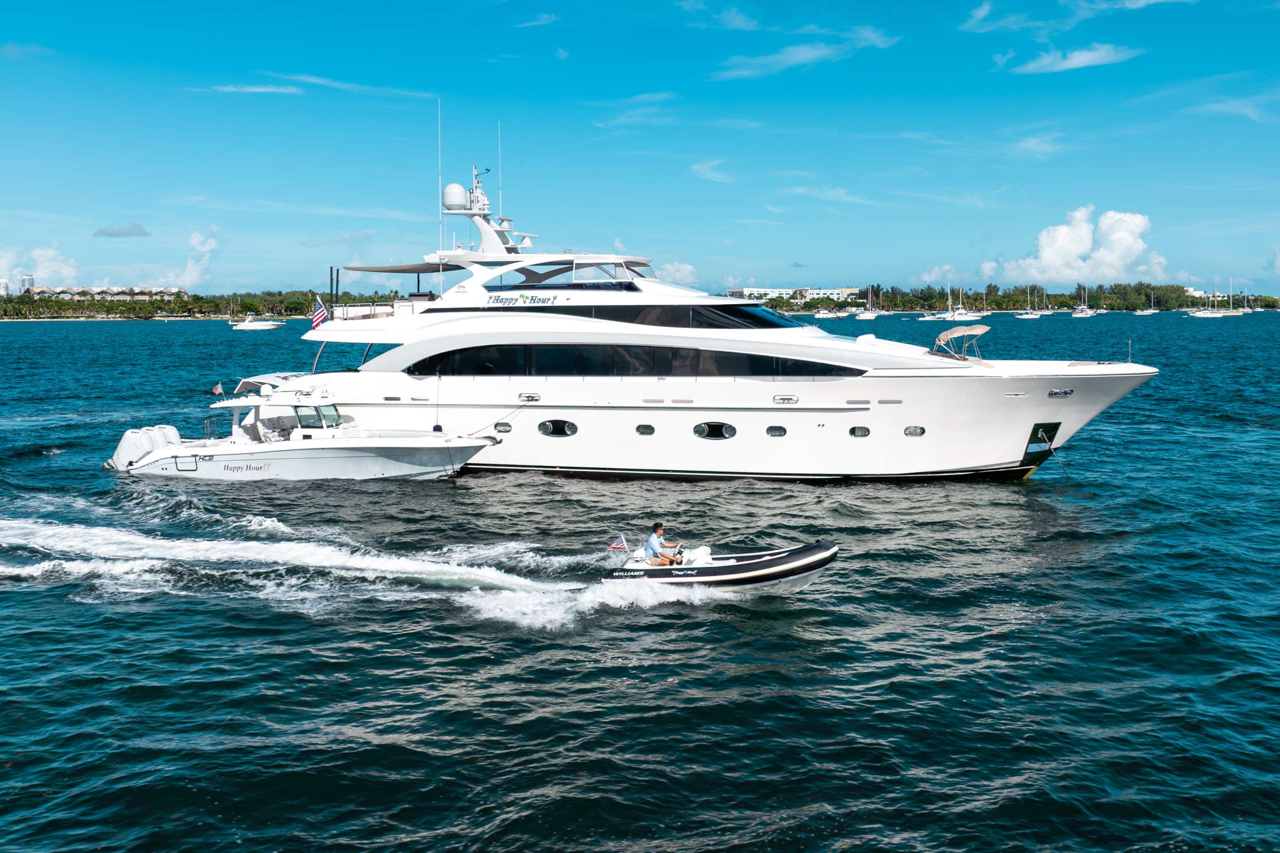 With her sleek lines, inviting spaces, and effortless style, HAPPY HOUR is the ultimate yacht for those who love to relax, entertain, and, of course, enjoy a perfect “happy hour” at sea.
Lovingly maintained and beautifully presented, HAPPY HOUR offers a seamless blend of comfort and sophistication. Her bright, contemporary interiors feature warm wood tones, neutral furnishings, and large windows that fill the space with natural light, creating an open and relaxing atmosphere throughout.
Accommodating up to 10 guests in 5 beautifully appointed staterooms, HAPPY HOUR boasts a full-beam master suite on the main deck offering exceptional space and privacy, complete with a king-sized bed, ample storage, and a luxurious en-suite bath. Below deck, guests will find two elegant queen staterooms, each with its own en-suite, as well as a convertible cabin that can be arranged with either two twin beds or a queen bed. A separate cabin with twin beds and a Pullman provides added flexibility, each with its own en-suite bath—ensuring every guest enjoys a private retreat.
Above deck, HAPPY HOUR truly lives up to her name. The expansive flybridge is the ultimate social hub, featuring a jacuzzi, full bar, alfresco dining, and plush lounging areas—the perfect setting to sip cocktails, share stories, and watch the sunset during your very own “happy hour.” Forward, the bow lounge provides an intimate space to unwind with a drink in hand, surrounded by ocean views.
Inside, the spacious main salon offers a sophisticated atmosphere with a formal dining area and comfortable seating, ideal for entertaining or relaxing after a day on the water.
Whether you’re soaking in the jacuzzi, dining under the stars, or toasting to unforgettable moments with friends and family, HAPPY HOUR delivers the ultimate charter experience—where every hour feels like happy hour.