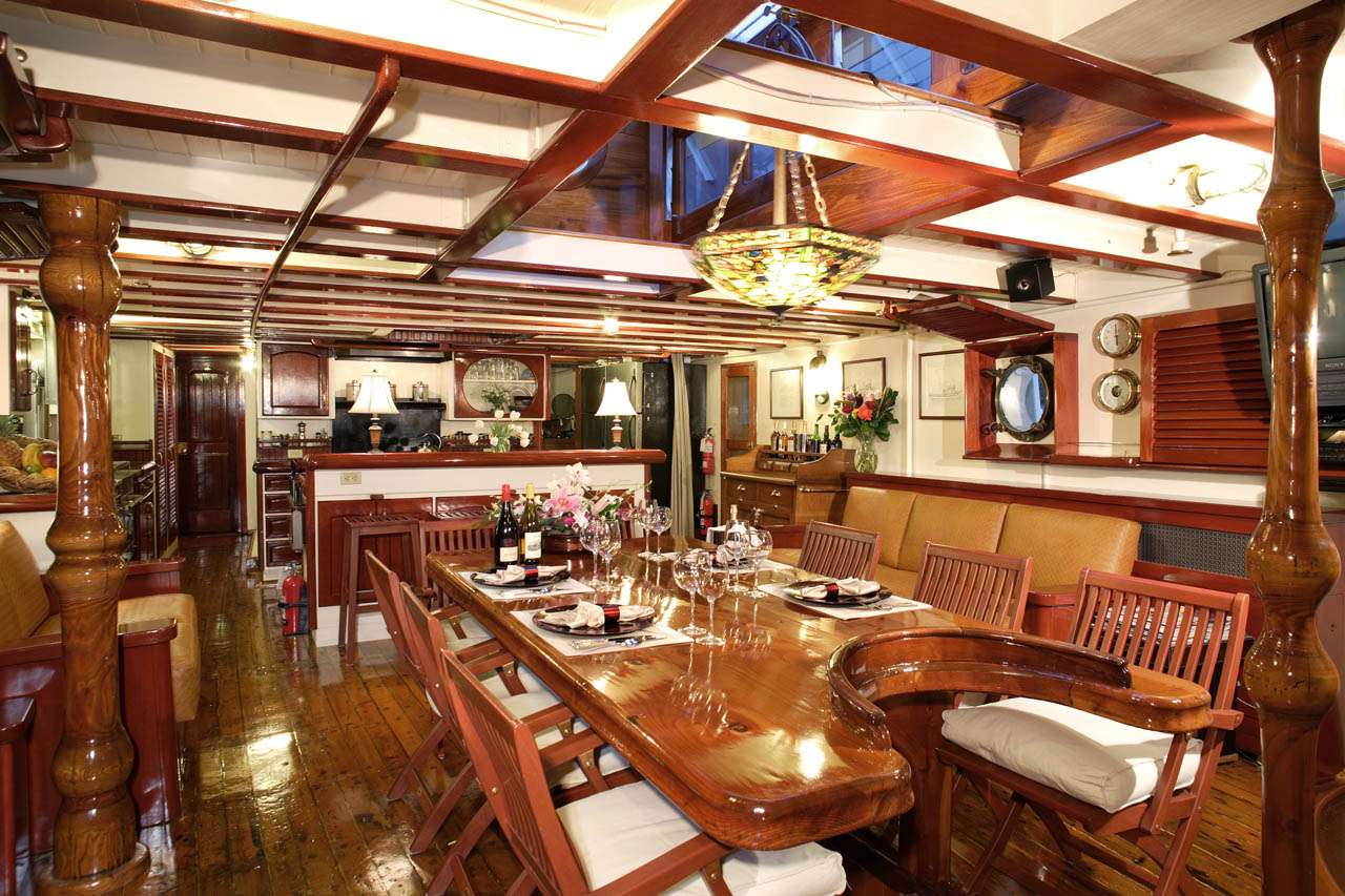 PACIFIC YELLOWFIN Yacht Charter - Main Salon. Country Kitchen in the far end.