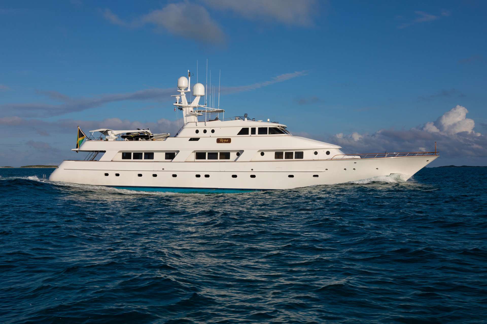 Well suited for both intimate family and large group charters, RENA offers luxurious accommodations, varied outdoor entertainment areas, and a large selection of water toys. At 145-feet long there is plenty of space to relax, unwind, socialize, or play depending on the mood ensuring you experience an unforgettable yacht charter vacation.
RENA accommodates 10-12 guests in five spacious staterooms each with ensuite bathrooms and state-of-the-art entertainment centers. Four are located on the lower level including a full-beam Master stateroom with a king-size bed and Jacuzzi tub as well as three guest staterooms. Each guest stateroom comes with queen and twin beds and Jacuzzi tubs while two of the guest rooms have Pullmans if needed. A spacious VIP stateroom with large windows is located on the main deck, featuring a king bed and Jacuzzi tub.
For those wanting to enjoy the sun and the stunning vistas of the Bahamas, RENA provides ample outdoor living areas including a bilevel sundeck with plenty of seating and lounging space; a spacious aft deck perfect for al-fresco dining with lounge chairs that offer a prime spot for sunset cocktails; and bow seating where you can enjoy an uninterrupted serene morning with coffee in hand.
For on water enjoyment, RENA’s wide selection of onboard toys offer activities for guests of all ages to enjoy. From watersports to fishing to relaxing on the beach, RENA and her highly experienced crew has you covered.