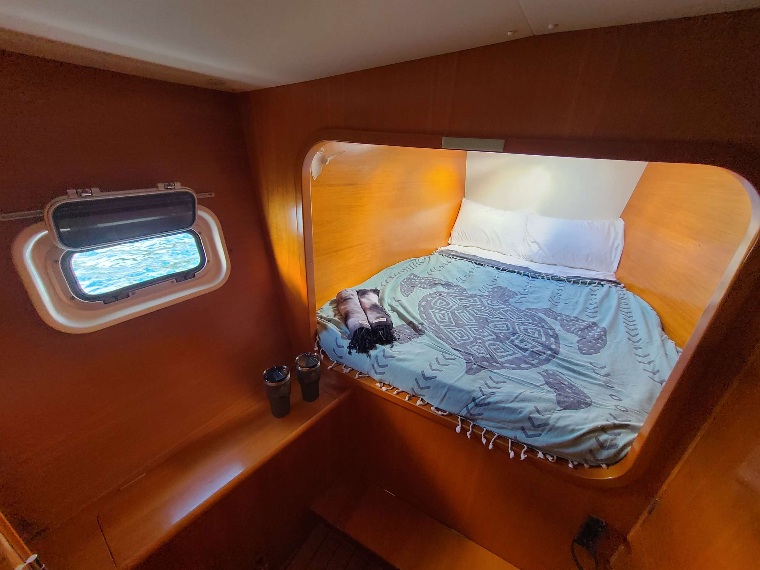 MIMBAW Yacht Charter - Port forward Stateroom Queen Bed.  All rooms have 2 fans and a hatch to catch natural ocean breezes.