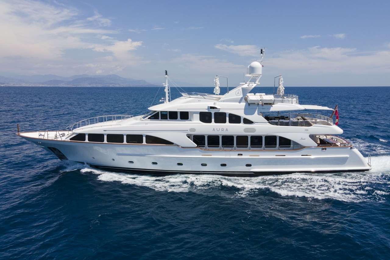 The overall impression that AURA provides is one of elegance and sophistication. The interior decor of this beautiful Benetti has a chic contemporary edge; with warm colours and attention to detail that create a relaxing and tranquil environment in which guests can unwind.
Audio & video systems are on demand throughout the yacht keeping her up to date with modern trends, including New Apple TV system, I-pod docking stations throughout, SKY TV, flat screen televisions in all cabins and lounges, portable TV + plug in points at all external seating areas including the sundeck, Jacuzzi and barbecue.
AURA sleeps 10 in sumptuous surroundings with 3 double and 2 twin cabins, all with exquisitely designed soft furnishings and marble bathrooms. The Owner’s Cabin and Bathroom are sheer opulence themselves, with gorgeous silks in softest ivory and gold and offering a stunning view from the panoramic bow window.
For those who prefer to be outside, AURA offers ultimate luxury in cool comfort with al fresco dining, deck Jacuzzi and an array of exciting water toys for the more adventurous charterer!
The yacht has a dedicated crew of 7 to cater for your every need and who, as you would expect from a yacht of this standard, offer a service to exceed expectation.
From the moment that you step on board AURA you know you are in good hands. Impeccable service, fine dining and all the little details that add together to make the difference between an ordinary vacation and a spectacular experience.