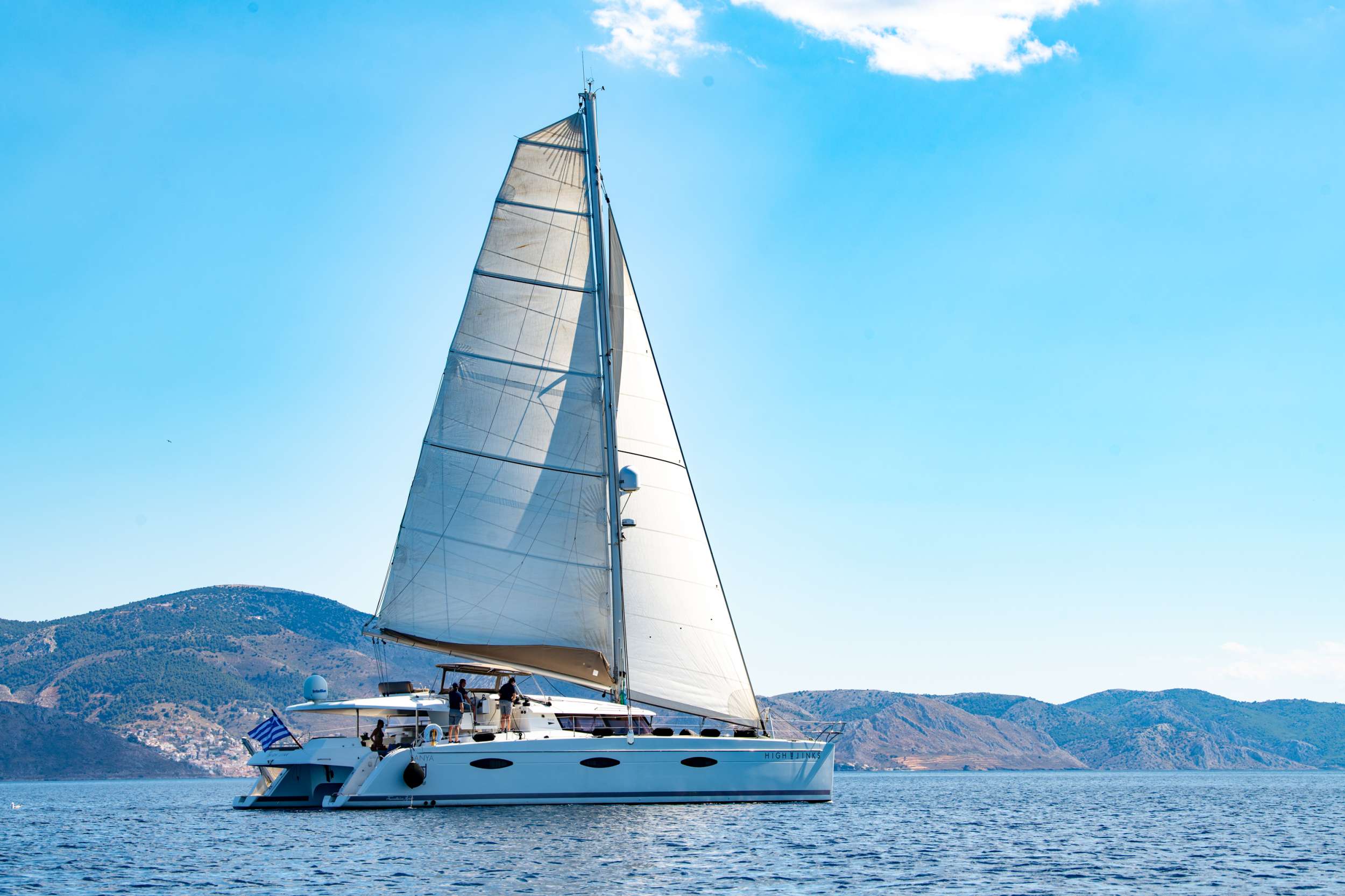 What are you looking for in your vacation? If you are aiming to take your family and friends on a memorable journey, living an adventurous, yet also relaxing and comfortable, tour among the magnificent Greek islands, sailing through the crystal blue seas of the Aegean or the Ionian, then this impressive and luxurious boat, HIGH JINKS SANYA 57, a definitively elegant and innovative catamaran with a unique, contemporary design by FOUNTAINE PAJOT, is going to fulfil all your desires and expectations.
With all the pleasures of the sea, with the distinctive comfort, fixtures and services you’ve come to expect from our Flagship Class, HIGH JINKS will embrace you and will book a place in your heart. The memories you will create on this boat, will be cherished for ever.
HIGH JINKS can accommodate up to 8 guests in 1 King size cabin, which features an exclusive suite with a lounge, desk and spacious designer bathroom and three generous Queen size cabins, all equipped with private bathroom facilities. All cabins have been especially designed for maximum comfort and space and have full air-conditioning, TV, DVD and stereo system integrated.
HIGH JINKS SANYA 57 offers the luxury and comfort of a fine hotel. Wide staircases beckon to the tranquility and privacy of beautifully appointed cabins.
The salon, with its soft colors and flexible seating areas is the perfect place, if you want to hide from the sun and yet not loose contact through the panoramic view with the outside world or if you just want to guess what kind of mouth-watering, delicious culinary delicacies your Chef is going to prepare for you.
The aft deck, where you probably will spend most of your time at, is stylishly designed for your comfort, either when gathering around the table to enjoy a fabulous meal, filling the air with Mediterranean flavors, or simply relaxing, with an aperitif in your hand, after an exhausting day, playing with the numerous water toys, such as water skis, kayaks, paddle board, wake board, knee board, tubes, snorkeling gear etc., you have on board. Then again if you like fishing and catch something, your Chef can prepare it for you the same day and serve it to you in the most delicious way, you can imagine.
The fore deck is the absolute ideal area for sun-bathing on comfortable sun mattresses, a trampoline, and the best location, if you see any dolphins swimming alongside the boat. The Fly-bridge is the ultimate favorite place for enjoying a glass of champagne accompanied by a finger-licking hors d'oeuvre, while gazing onto the horizon and harmoniously savouring the dreamlike scenery during a sunset.
The sailing catamaran HIGH JINKS SANYA 57 will bring you to the most beautiful places in the Mediterranean while traveling in all comfort and privacy. Guided by her crew you will yourself discover the magnificent islands, nature and culture and most importantly the magnificent clarity of the Greek crystal blue waters.
Modern and minimal in design with an excellent crew of three.
Awards:
*2nd Place Emerald Category, CYBA Designer Water Competition, EMMYS 2024