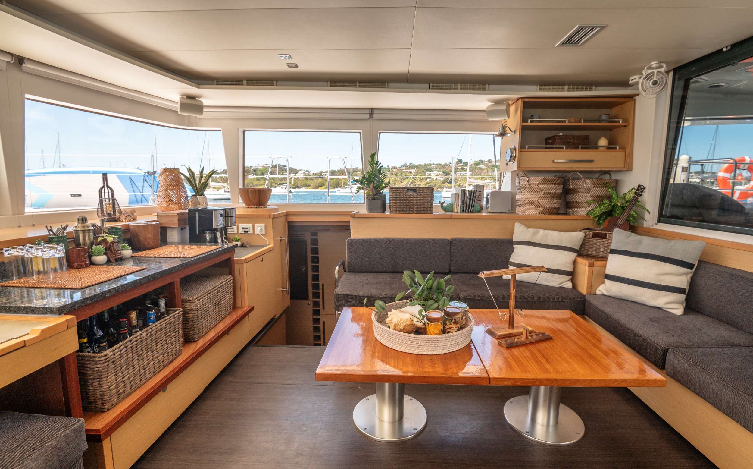 BLUEWINDS Yacht Charter - Saloon with updated bar, teak table and seating
