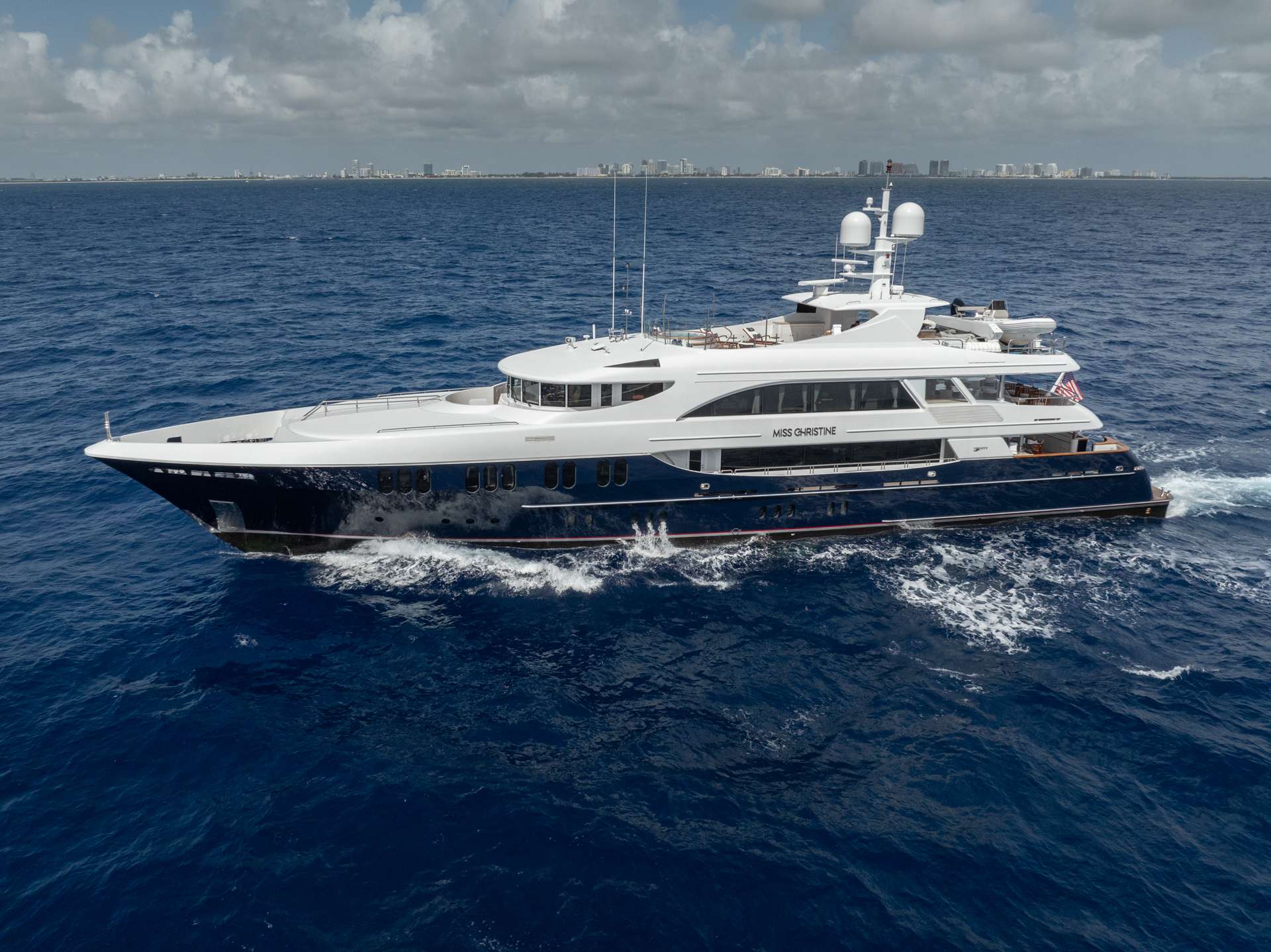 MISS CHRISTINE was christened in 2006 and built by Trinity Yachts. She has been impeccably maintained through the years and recently refit.MISS CHRISTINE features a dark cherry wood interior. Her highly customized interior features custom accents and artwork in ceiling panels of the main salon and sky lounge, a custom artwork piece in the dining salon and handpicked inlaid marble throughout her interior and master bathrooms. At 157’ long and 28’ wide, her interior and exterior offer guests abundant space along with luxurious surroundings. The shallow draft of 7’ makes her a top pick for cruising in the Bahamas. MISS CHRISTINE is equipped with an ultra-modern stabilization system which reduces the roll motion while underway and at anchor. This ensures guests are comfortable at all times on board. The main salon offers a lounging area with entertainment system as well as formal dining forward. The sky lounge layout includes a full sit down bar, game table and comfortable living room area. The aft deck on the main salon level has a beautiful wood table for dining and access to the swim platform and all of the water toys. On the sky lounge many fun themed dinner parties happen at the enormous round table for 12 and there are also aft lounging areas and stairs to the sun deck. The Jacuzzi on the sun deck is a popular guest area and there are sun beds surrounding, a dining option, gym equipment, an assortment of water toys. MISS CHRISTINE operates with a crew of 9 who have many years of charter experience and several charter groups that have returned for multiple charters.