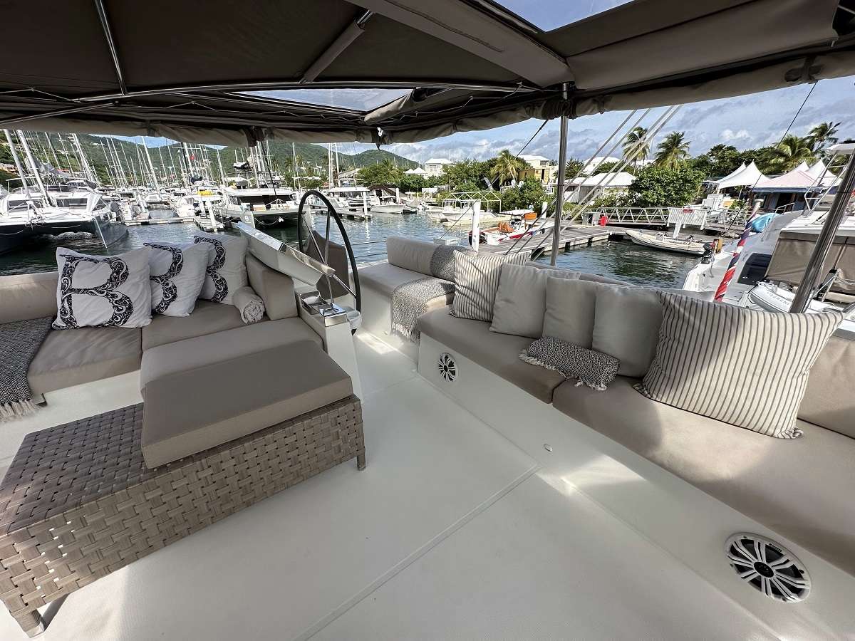Flybridge and helm station. Chiller for cold beverages. The bimini offers drop down clear sides for protection from wind and rain if needed.