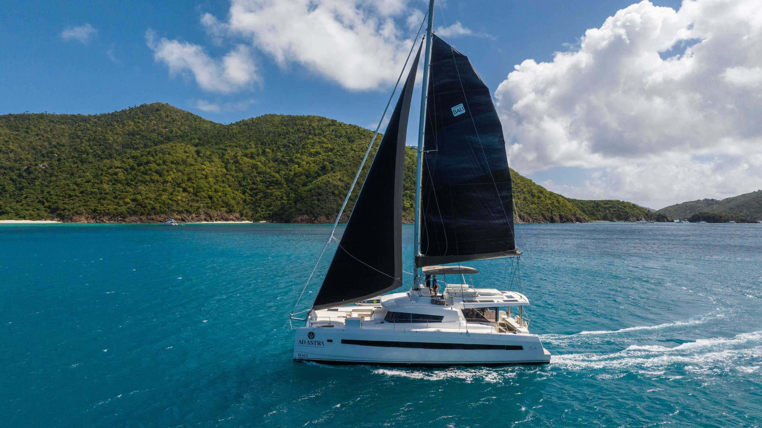 “The Stars are Calling”
Ad Astra will accommodate 10 charter guests in 5 spacious queen cabins. She is a 2020 sailing catamaran with black sails, eight extra powerful underwater lights, 60hp outboard dingy, flexiteak on both the aft and front of the yacht, solar panels, air conditioning, water maker, ice maker, full sized refrigerator, a fully customizable menu, ecofriendly and reef safe toiletries, a bar stocked to guest preference, coffee/espresso machine, rendezvous scuba diving, snorkeling gear, underwater scooters, wakeboard, stand up paddle board, ski tube, 10 ft. floating dock, pool noodles, fishing gear, board and card games, television in the salon, Fusion 3 Bluetooth enabled sound system and Ad Astra giveaways.