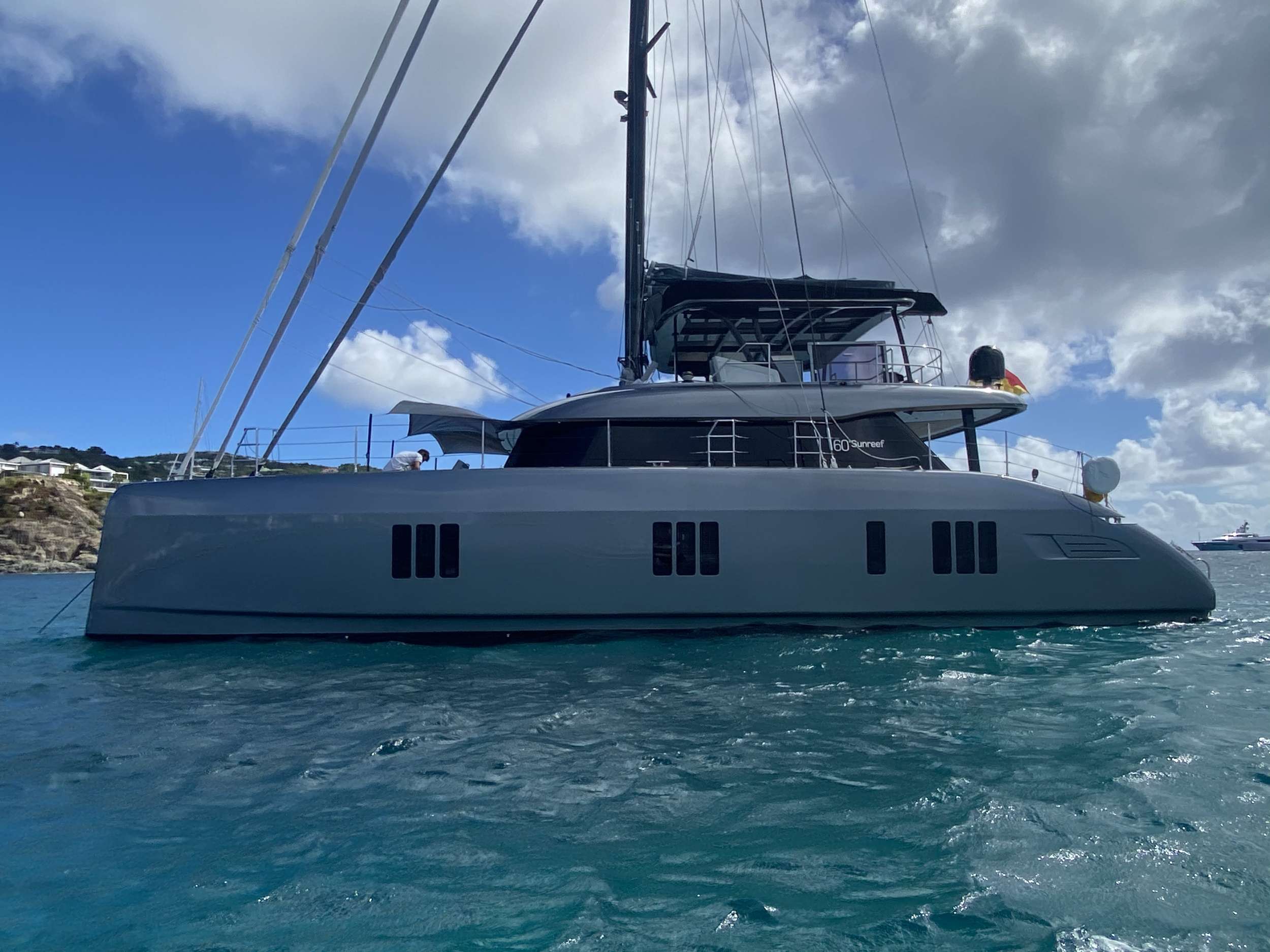 Launched in September 2020, luxurious Sunreef 60 sailing catamaran CALMA offers 225 m² of living space to enjoy life on board.
CALMA’s layout features five exclusive double ensuite cabins for ten guests, a stylish saloon with cosy lounging and dining areas, and a functional galley up, giving the chance to watch a professional chef in action.
Thanks to the sliding saloon door the interior blends naturally with the outside, opening onto the large, sheltered aft deck and the splendid front terrace. The spacious flybridge features a BBQ, a wet bar and plenty of seating for enjoying the beautiful panoramic views.
Operated by an experienced crew of 3, this grey-hulled beauty is available in the Caribbean in winter and in the Balearics in summer.