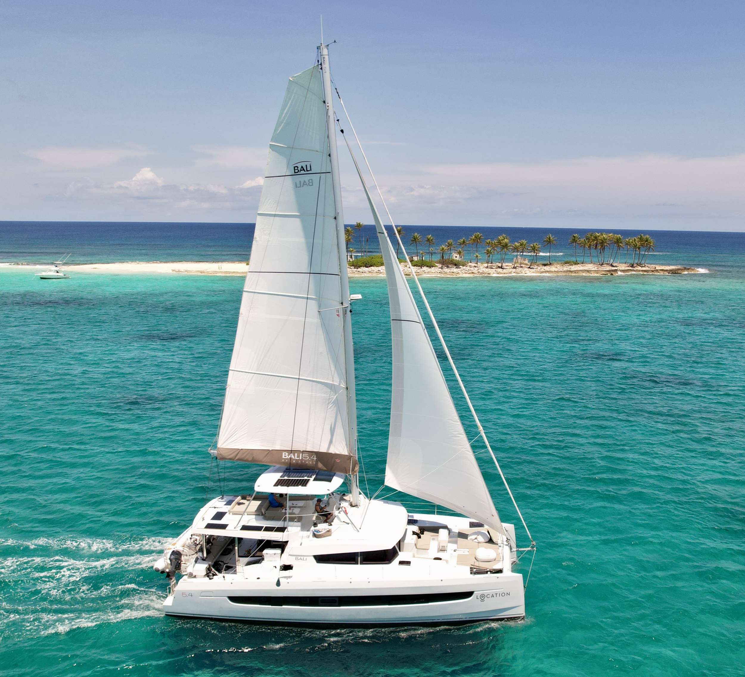The luxurious sailing catamaran, LOCATION, is a superb example of what Bali can design. As you step on board in to a beautifully appointed cockpit, complete with teak floors and dining table for ten and a comfortable lounging bench, you immediately realize what a unique charter experience you are about to have. As you make your way up to the flybridge you’ll be blown away by the amazing turquoise water with 360° views and enjoy the up-close view of the sails. It’s also a great place to read your favorite book or a favorite spot for appetizers and cocktails at sundown. The main salon is comfortable and luxurious with open spaces and natural light fed by all the windows surrounding you. All guest cabins are spacious with large windows and offer plenty of natural light. For your comfort, every cabin offers queen sized beds and private baths with dedicated shower stalls as well as individual cabin A/C control. The high level of finishing throughout every cabin reflects the luxury that you would expect from a yacht of this caliber. With all the different areas, LOCATION is show-stopper and has enough amenities for everyone to enjoy!