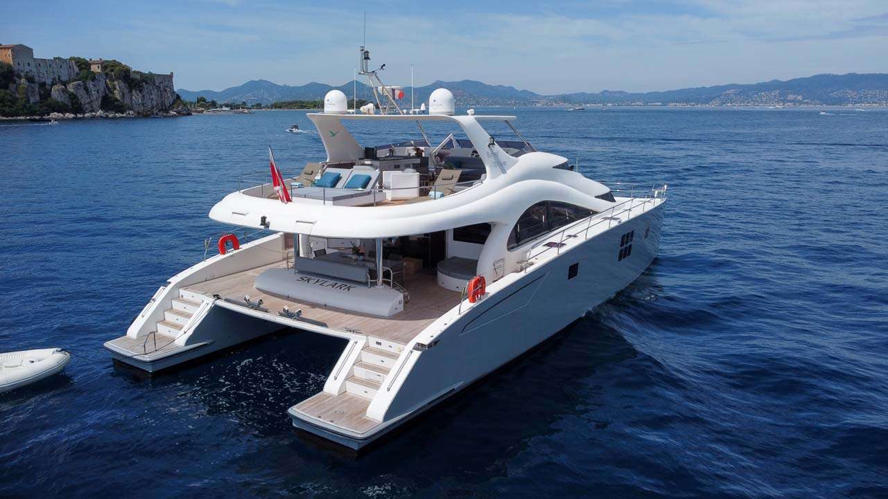 Who's ready for the trip of a lifetime aboard a luxury catamaran? Introducing SKYLARK, an 70' (21.34m) Catamaran built by the renowned Sunreef Yachts. Ideal for cruising the stunning Mediterranean waters, SKYLARK offers world-class service with unparalleled 360º ocean views. Four well-appointed staterooms will greet you with plush comfort upon arrival. The generous full-beam master stateroom is outfitted in contemporary wood finishings and a panoramic ocean view from the moment you wake up. Her modern yet organic atmosphere offers unique wood finishings, allowing for the ideal oasis.
Boasting a multi-hull design, SKYLARK provides maximum stability both at anchor and underway. SKYLARK is as powerful as she is efficient. Low fuel consumption is just one of the many attributes that make SKYLARK the perfect yacht for your next vacation. Boasting an exterior that's just as impressive, SKYLARK features a spacious sunbed on the fly for you and your guests to enjoy. The perfect spot for those cool nights on the water, the sun deck offers ample seating areas for sunbathing, lounging, or dining al fresco! SKYLARK also features a generous swim platform, perfect for a quick dip or a day on the water. However you choose to spend your next Mediterranean yacht vacation, let SKYLARK take you there.