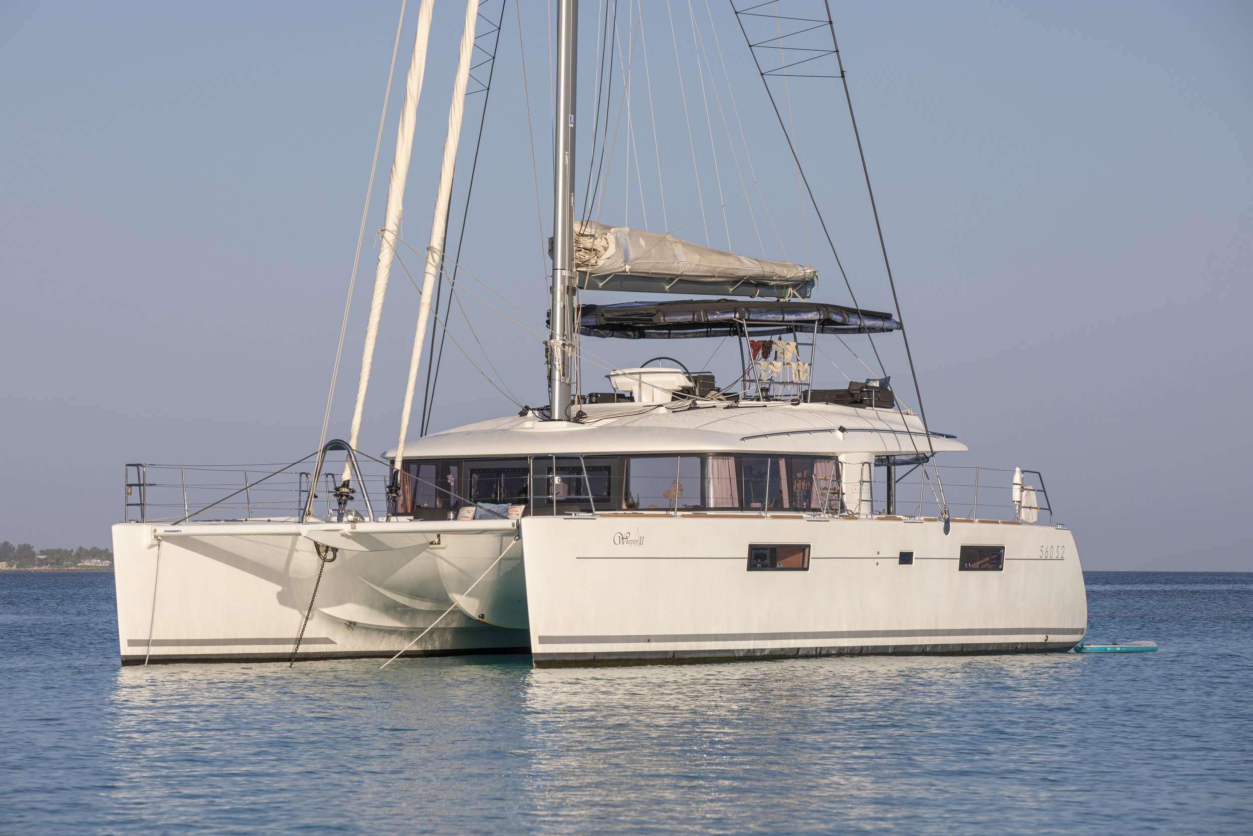 Swift and elegant in her design, luxury sailing catamaran Whispers II offers guests a first class sailing holiday in the Bahamas. With stylish open living areas, plenty of deck space for lounging in the sun, and exceptional amenities, this superb 56’ model of Lagoon from CNB Bordeaux is a perfect choice for those who value modern sophistication.
Charter yacht Whispers II is a guarantee of a relaxing yachting getaway in the most beautiful of surroundings. Her contemporary interior is designed with pure elegance and comfort in mind. The salon with panoramic windows allowing natural light to flood through, comfortable furnishing and spacious seating area is a perfect place for indoor relaxation. Up to 8 guests can be comfortably accommodated in four elegantly-designed double ensuite cabins.
Deck areas of Whispers II offer a variety of options for outdoor activities – from soaking up the sun on the flybridge, enjoying alfresco meals on the aft deck to lounging on the forward trampolines. Moreover, enthusiasts of water sports will highly appreciate a wide assortment of toys which includes kayaks, snorkeling and fishing gear.
With a professional crew of two whose highest priority is providing guests with an unforgettable charter experience, Whispers II offers a heavenly sailing holiday in superb comfort and style.