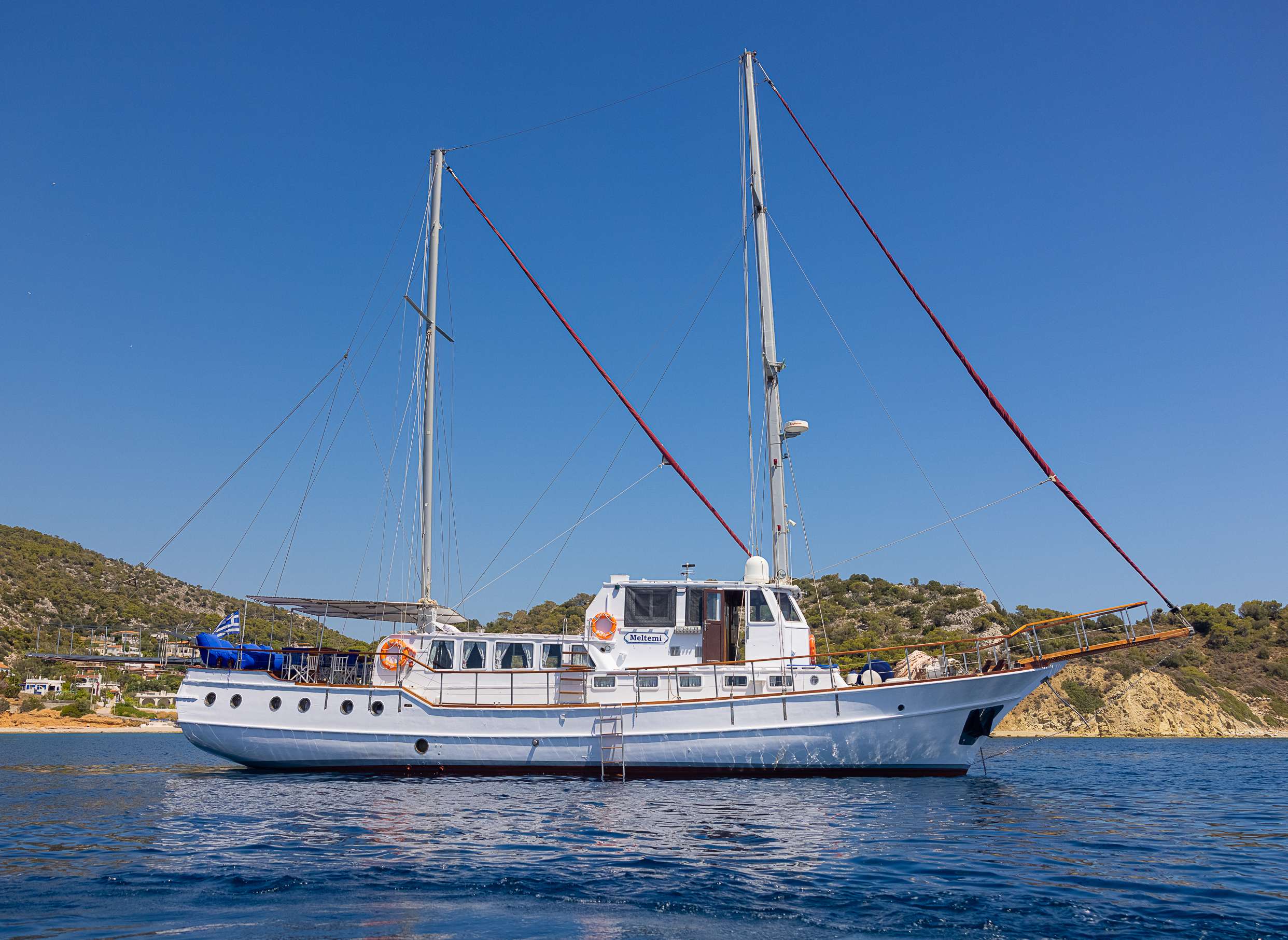 Side View of Meltemi anchored at a Greek beach