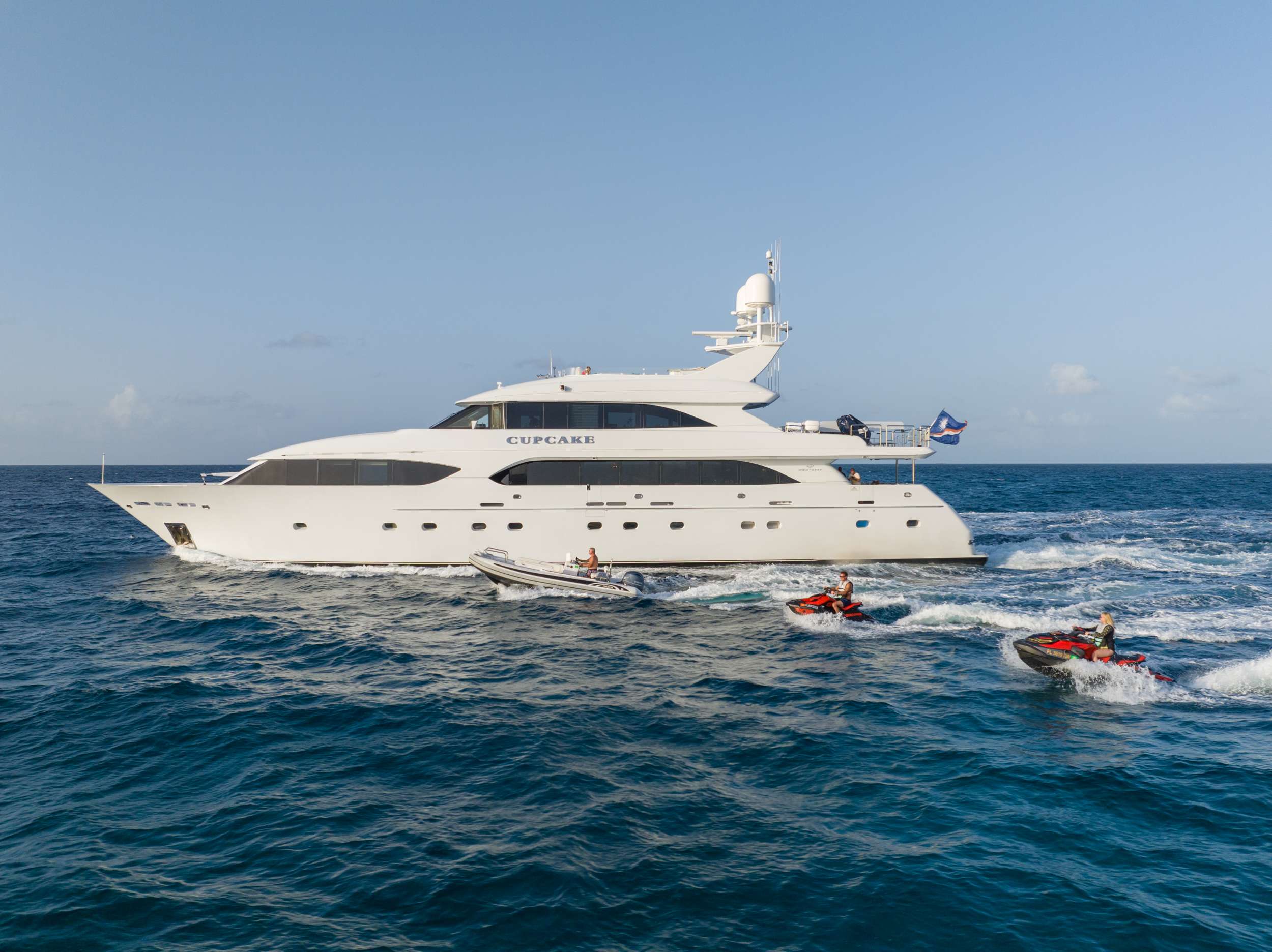 You're in for a sweet treat aboard Motor Yacht CUPCAKE. This 132' Westship features neutral tones of cream and turquoise complemented with mother of pearl accents which create an unobtrusive and calming environment. Her dedicated crew of 8 is led by the enthusiastic and energetic Captain Sean Hartel. CUPCAKE is fully stocked with the latest in water toys including a 39' HCB 2024 Tow Tender w/2 x 600hp Mercury Engines, 20' RIB Beach Lander, 2 Waverunners, 2 SeaBobs, E-foil, Partybana and more.
Accommodations include a generous on-deck full-beam owner's suite with King size berth. Her ensuite bathroom includes a separate shower and a deep Jacuzzi bathtub. On the lower deck, there are 4 further staterooms comprising of 1 King, 2 Queens, and the 5th stateroom featuring a queen, twin, and pullman. Each guest stateroom features an ensuite shower freshly refitted with new tile, shower fixtures, and tons of storage space for all of your cute swimsuits! Her spacious main salon offers plenty of comfortable seating to relax and chat. This area is complete with a large flat-screen TV, multi-stool bar, panoramic windows, and formal dining for 12 guests. Moving up to the skylounge, you and your guests can double down on the fun at the custom-built blackjack table, sip some cocktails at the bar, or enjoy a movie on any streaming service with the large smart TV. Stepping out from the skylounge, you'll find ample seating along with some extra sun loungers for that perfect sun-kissed glow. You can access the Sundeck, complete with a lounging pad, Jacuzzi tub, wet bar, and 2 tables with large umbrellas, allowing for tons of shade. CUPCAKE is sure to be a delectable treat for all who step aboard.