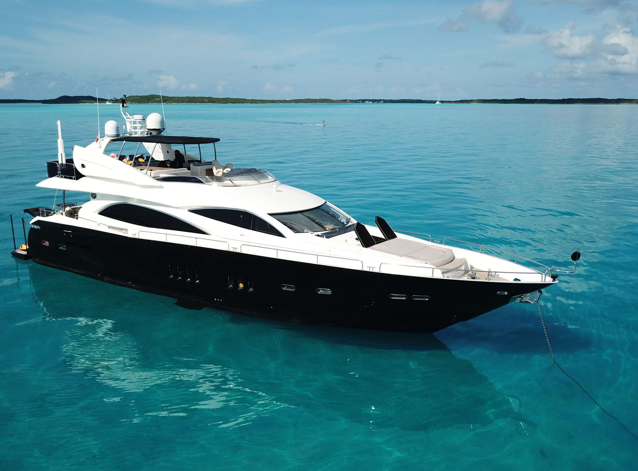 M/Y CATALANA was designed specifically with safety as a priority. While she still has the sleek and stylish feel of a Sunseeker and is capable of speeds up to 30 knots, this flybridge motor yacht has many safety features discretely added throughout, guaranteeing peace of mind at all times. Built in 2007 and comprehensively refitted in 2018, CATALANA is a modern yacht for charter, well suited to groups of any age to cruise around the Bahamas in style.

On deck, the spacious fly bridge provides more than enough room for a relaxed seating area along with a wet bar and plenty of space for lounging in the sun. Her resourceful storage arrangement provides easy access to the tender, as well as allowing for plenty of onboard toys to be ready for entertaining. CATALANA&rsquo;s large bathing platform can be lowered up to 1m below water level providing easy access straight into the water.

The attractive wooden flooring in the salon and dining areas gives the yacht a cool, spacious and elegant feel. The tasteful and modern d&eacute;cor throughout the yacht provides an elegant setting whether for dining or lounging, and includes a state of the art entertainment system. Outside on the aft deck, a large table provides comfortable alfresco dining for up to ten people and the enlarged galley with extra storage facilities enables the chef to easily cater for groups of this size and more. Below decks, CATALANA&rsquo;s versatile cabin arrangements can accommodate up to 10 guests in 4 cabins or a combination of twins and doubles, each with en-suite bathrooms. All cabins are stylishly decorated in neutral tones, and each has its own TV and entertainment system creating a natural environment for relaxing. Both guests cabins also have Pullman berths, perfect for young children.