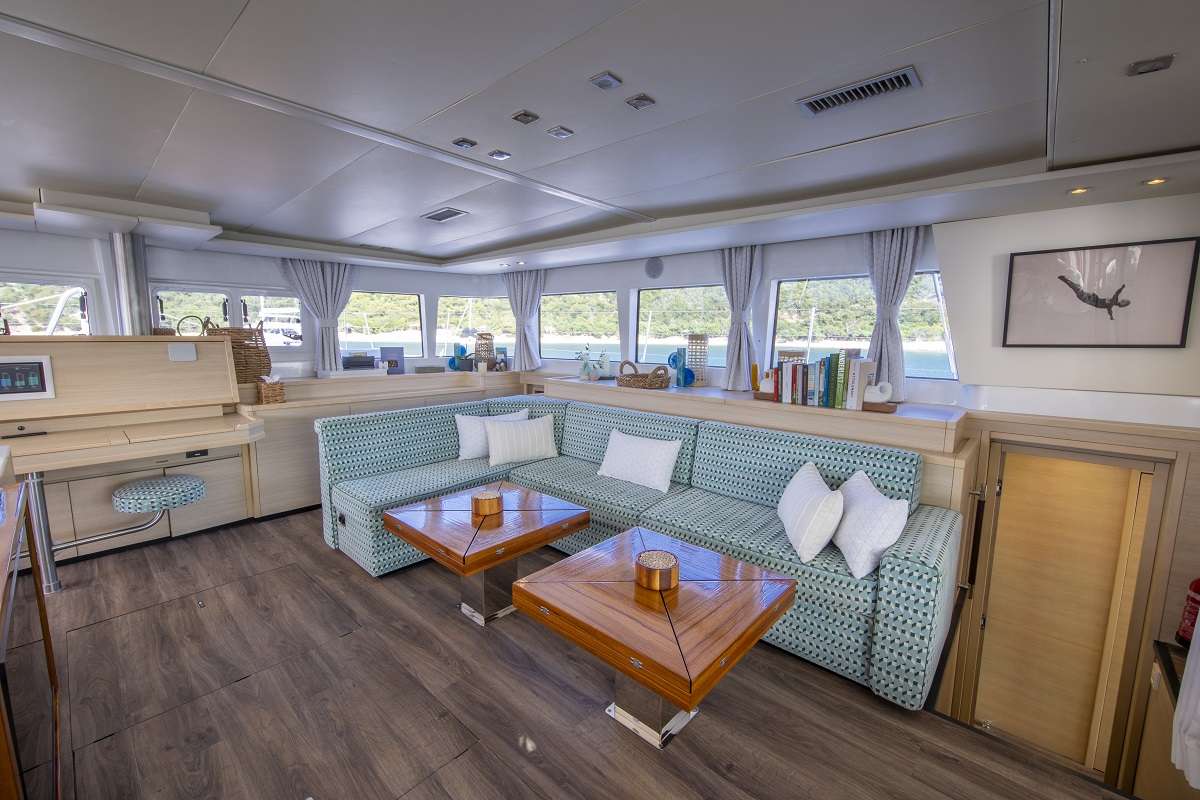 NOMADA Yacht Charter - Spacious central salon with Bluetooth stereo system, TV with streaming services, board games, and a library of 30+ books