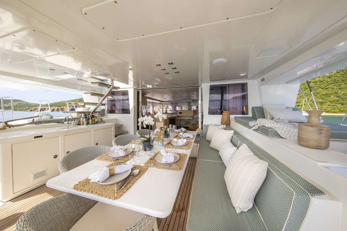 Stylish aft deck dining area comfortably seats up to 10 guests.