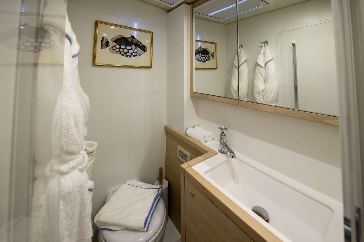 NOMADA Yacht Charter - En suite bathrooms with standing shower, plush robes, and artisanal bath &amp; body products created exclusively for NOMADA.