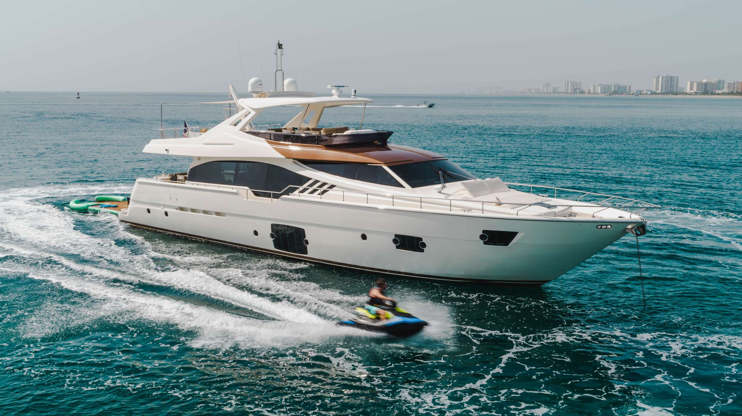 Top Shelf is a 87&prime;1&Prime; luxury motor yacht built by Ferretti in 2014. With a beam of 21ft and a draft of 6.5ft, This adds up to a gross tonnage of 133 tons. She is powered by twin MTU engines of 1950 hp each giving her a maximum speed of 30 knots and a cruising speed of 22 knots with a maximum range is estimated at 400 nautical miles. She has two 23kw Onan Generators, a 60 gallon a minute fresh water maker, twin washer/dryer combos and three icemakers. 10 brand new 10,000 lumen Underwater lights were just installed as well. Top Shelf is also equipped with two internal anti roll gyro stabilizers to make your stay as comfortable as possible.
The motor yacht can accommodate 8 guests in 4 cabins. Each cabin has its own bathroom and shower as well as a separate day head on the main deck. The Flybridge is very spacious with a retractable roof to give you unobstructed views as well as a sunbed with adjustable headrests. The Bow has a spacious sunbed with retractable headrests that will comfortably fit 4 people.
Top Shelf has a garage that when in the down position doubles as a beachfront so that you can hangout at the waters edge. 

M/Y Top Shelf Is Best Described As A Family Fun Style Yachting Experience 

14ft Jet tender, SeaDoo Spark Jetski, 2x SeaBobs, 10x10 Floating Pad, Bote Hangout, Snorkeling Gear, Numerous Floats, Wake Board, KneeBoard, Towing Tubes, 2x Paddle Boards, 5x Land Electric Scooters, Beach Games Including Volleyball, Flag Football, Bocceball, and Badminton. 
We Also Have A Full Beach Setup Including Beach Games, Bonfire (Where allowed), Barbeque, Tents, Beach Chairs, Hammocks and More
4 bedrooms (king, 2 queens and 2 twins) all with their own bathroom and 1 day head upstairs. 

The crew are more than happy to take photos &amp; videos during our clients stay so that they always have something to remember the trip. Our photography equipment consists of: a DSLR Camera, GoPros, DJI stabilised pocket camera, cell phones and of course our DJI Mavic 2 Pro. All photos are uploaded every night to a google drive which is accessed by a QR code displayed in the salon for our clients to reminisce at the end of the day.