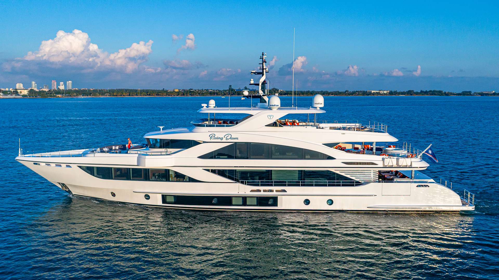 Winner of several prestigious awards for its thoughtful design and interior layout, the Majesty 140 redefines the meaning of superyacht by setting new standards in onboard space and entertainment features. Once you board RISING DAWN you will immediately see why the Majesty 140 has won “The Best Interior Design” at the Cannes Yachting Festival and “Best in Show” at the Fort Lauderdale International Boat Show.
RISING DAWN is the perfect charter yacht for friends and family with relaxing and entertaining being the center focus of the yacht. With three dining areas, you can enjoy your meal in a different location throughout the day. The main deck aft features two aft folding balconies, a unique feature for a yacht this size. Guests can enjoy being steps away from the water in the large beach club. A large jacuzzi is the center piece of the bridge deck aft with plenty of lounging and dining space. The sun deck is the perfect location for al fresco dining and the retractable awning so guests can dine under the starts at night.
RISING DAWN can accommodate up to 12 guests in 6 luxurious staterooms. The modern master stateroom is forward on the main deck and features an ensuite with a his and her sink and a large shower. Four staterooms are located below deck, all with their own ensuite. Two staterooms feature a queen bed and two twin staterooms with a pullman bed. The remaining stateroom is on bridge deck and features a queen.
The living interior space is inviting with large picture windows and light contemporary styling with comfort kept in mind. The main deck features a large L shaped sofa and an open formal dining area. The skylounge is the perfect place to unwind after a busy day and watch your favorite film.
RISING DAWN has an array of water toys and is accompanied by a 34' Grady White with twin 350 HP. She is complete with a professional and charter savvy crew of 10 who will make sure your charter is one that gives you memories to last a lifetime.