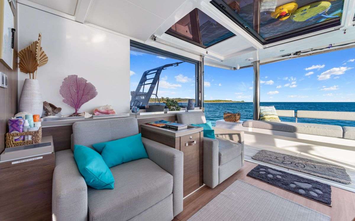 Across from the dining area are two nice size club seats. This is a very versatile indoor/outdoor area when the sliding windows are open and the back tilting door is up.