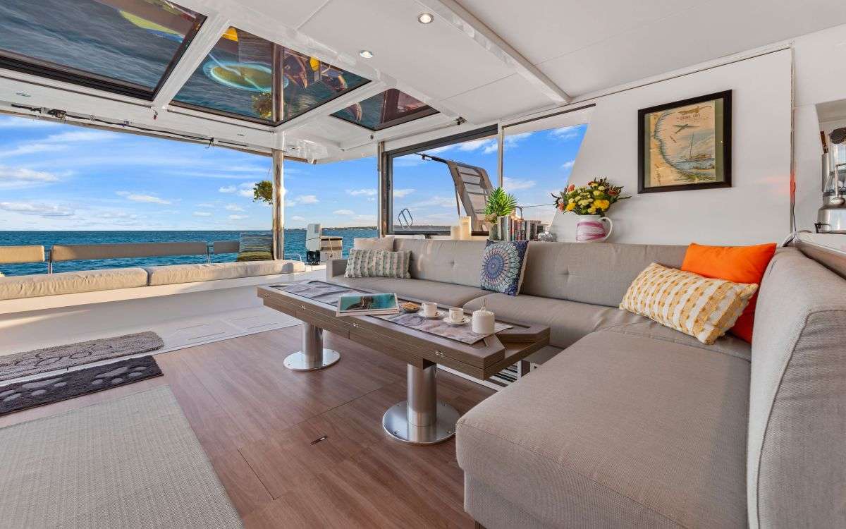 The main salon is open and inviting. It has a telescopic table that can be lowered to the height of a coffee table or raised and opened up for a dining table that can easily accommodate 8 guests.