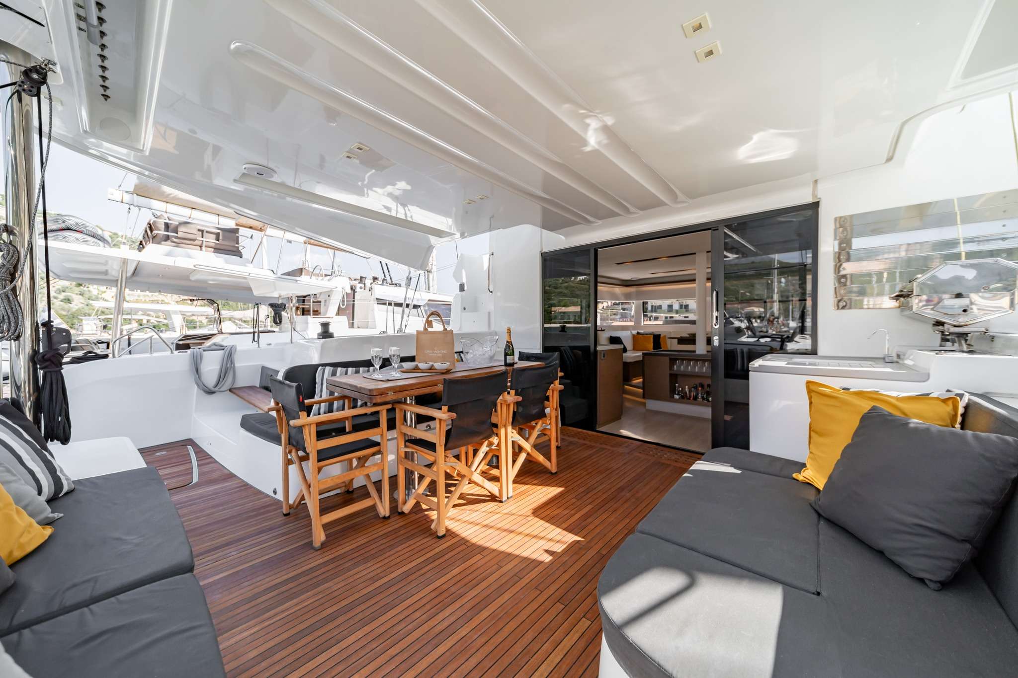 OZELO Yacht Charter - Cockpit area with custom designed large teak table