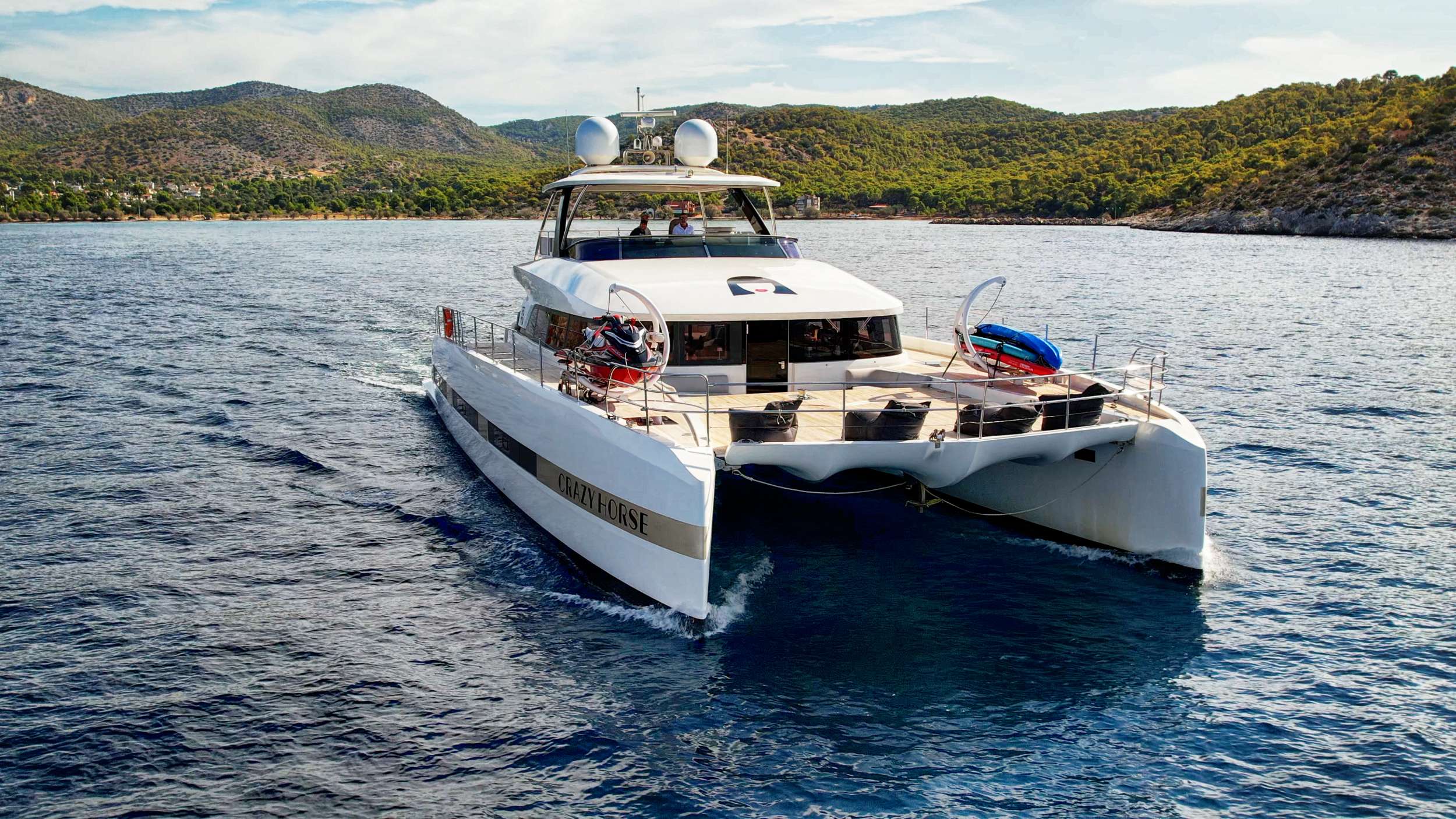 Motor catamaran Crazy Horse, a luxurious Lagoon 78, offers the ultimate sailing experience to guests seeking the combination of luxury and comfort. With 5 beautiful cabins, Crazy Horse has the capacity to accommodate up to 10 guests. Guests can expect to be wowed by the spacious and stylish ensuite cabins featuring modern amenities for a comfortable and unforgettable yachting experience.
Crazy Horse is staffed with an experienced and competent crew of 5. The team is dedicated to ensuring that guests have the trip of a lifetime.
Crazy Horse is available for charter in Greece and sails the crystal clear waters of the Mediterranean. Discover Greece's stunning coastline and hidden gems while enjoying the amenities aboard Crazy Horse. The yacht features spacious common areas for dining, socializing, and relaxation, including a stylish salon with a full bar and a state-of-the-art entertainment system.
Crazy Horse also has ample outdoor space for guests to bask in the Mediterranean sun and enjoy the stunning views. The flybridge offers comfortable seating, and sun-loungers to relax. The yacht also features a variety of water toys, including a jet ski, snorkeling gear, kayaks, paddleboards, and a yacht tender to take full advantage of amazing anchorages Complemented by an array of equipment, Crazy Horse serves as the perfect escape for those wanting to discover the beauty of Greece while being surrounded by the lap of luxury.