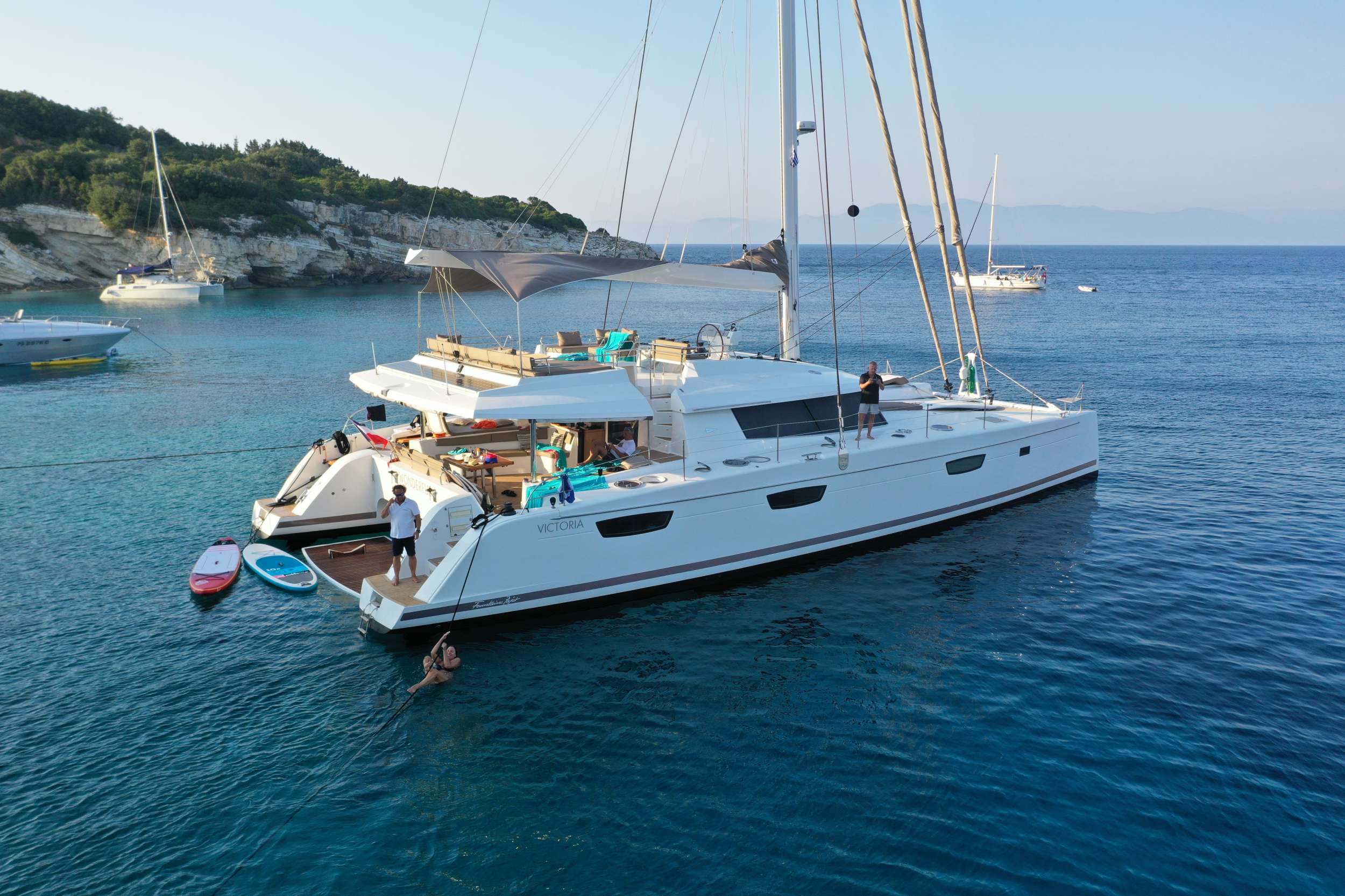 Some Kind of Wonderful is an exceptionally stunning custom-built Fountaine Pajot. Newly built and launched in 2016, she is a remarkable Flagship and top-of-the-line luxury catamaran designed for the most astute traveler. With her custom carbon fiber mast and boom, Kevlar standing rigging, extended hulls and keels she is lighter, faster, and stronger than the standard Victoria, ensuring guests reach their destinations quickly and smoothly whether under power or sail.

Some Kind of Wonderful is strikingly sleek, extraordinarily elegant, and exceedingly spacious with an overall length of 72 feet and beam of 31 feet. She is the epitome of cruising luxury. Previously privately owned and professionally crewed, Some Kind of Wonderful is new to the charter fleet in 2023.

The luxuriously appointed interior and notable design of Some Kind of Wonderful have been perfected for socializing with never-ending space both above and below deck. With a multitude of dining, living, sunbathing, and lounging areas to choose from, guests are presented with numerous options to create timeless memories in a spectacular retreat. The salon is open and airy with large windows that ensure beautiful 360-degree scenery. The salon features an inviting sofa for lounging or watching movies on the large cinema screen. The open galley has seemingly endless counterspace and is equipped with all new state-of-the-art appliances, fine porcelain tableware, and elegant glassware.

The exterior of Some Kind of Wonderful is most impressive! The highlight of the yacht is the exceptionally large flybridge with dual access points for safe and convenient movement onboard. There is ample space for the captain to maneuver at the helm, with nearby seating to allow guests who want to be a part of the sailing experience to stay close to the action. The flybridge boasts an oversized c-shaped sofa, 2 cocktail tables, 2 bench seats, 2 lounge/day beds, and versatile awning. The flybridge's 2 convenient refrigerators maintain deliciously cold beverages and cocktails to enhance the picturesque views, tranquil sunsets, and evening breezes. The substantial aft deck is shaded by the flybridge overhead and provides 2 additional bench seats, 2 lounge/daybeds, as well as an elegant setting for formal dining. The foredeck with 2 additional lounge/daybeds, 2 bow pulpit seats, and 2 trampolines is a wonderful place for lounging, spotting turtles or dolphins, and immersing in the incredible views while underway.

Some Kind of Wonderful accommodates 8 guests in 4 cabins: 1 king primary suite, 2 queen suites, and 2 twin beds that can be converted to a king upon request. Each cabin has a private ensuite bathroom with separate dry shower stalls, independent air-conditioning, complete with the finest quality bed linens, towel sets, and beach towels. The primary suite is vast and elegantly appointed, with additional seating/lounge area, a television, a desk/dressing table, king size bed, and the ensuite bathroom with separate oversized glass shower stall and double vanity. 

Some Kind of Wonderful is equipped with all new water toys including stand-up paddleboards, double kayak, 360 hangout, snorkel gear, knee board, tube, water skis, and more. The extended tender platform converts to a swim platform for easy access to water activities.

After an adventure-filled day of sailing, water sports, swimming, or on-shore excursions, appreciate the well-lit and immense cockpit dining area as you enjoy an extraordinary meal with your friends and family. Take pleasure in a handmade cocktail prepared just for you by your professional crew. You will appreciate firsthand the meaning of serenity, relaxation, and elegance when you charter with us on Some Kind of Wonderful. Your experienced Captain and accomplished Chef await your arrival in paradise to create unforgettable moments and memories to last a lifetime.