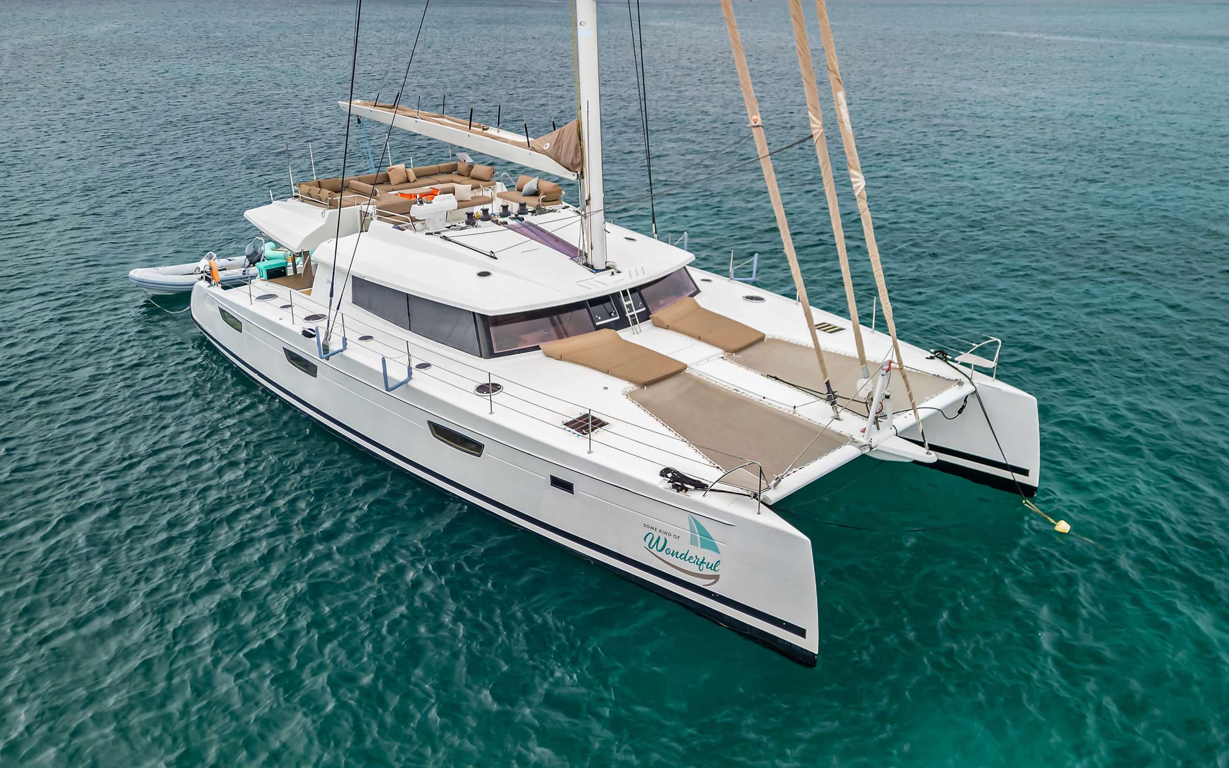 Some Kind of Wonderful is an exceptionally stunning custom-built Fountaine Pajot. Newly built and launched in 2016, she is a remarkable Flagship and top-of-the-line luxury catamaran designed for the most astute traveler. With her custom carbon fiber mast and boom, Kevlar standing rigging, extended hulls and keels she is lighter, faster, and stronger than the standard Victoria, ensuring guests reach their destinations quickly and smoothly whether under power or sail.

Some Kind of Wonderful is strikingly sleek, extraordinarily elegant, and exceedingly spacious with an overall length of 72 feet and beam of 31 feet. She is the epitome of cruising luxury. Previously privately owned and professionally crewed, Some Kind of Wonderful is new to the charter fleet in 2023.

The luxuriously appointed interior and notable design of Some Kind of Wonderful have been perfected for socializing with never-ending space both above and below deck. With a multitude of dining, living, sunbathing, and lounging areas to choose from, guests are presented with numerous options to create timeless memories in a spectacular retreat. The salon is open and airy with large windows that ensure beautiful 360-degree scenery. The salon features an inviting sofa for lounging or watching movies on the large cinema screen. The open galley has seemingly endless counterspace and is equipped with all new state-of-the-art appliances, fine porcelain tableware, and elegant glassware.

The exterior of Some Kind of Wonderful is most impressive! The highlight of the yacht is the exceptionally large flybridge with dual access points for safe and convenient movement onboard. There is ample space for the captain to maneuver at the helm, with nearby seating to allow guests who want to be a part of the sailing experience to stay close to the action. The flybridge boasts an oversized c-shaped sofa, 2 cocktail tables, 2 bench seats, 2 lounge/day beds, and versatile awning. The flybridge's 2 convenient refrigerators maintain deliciously cold beverages and cocktails to enhance the picturesque views, tranquil sunsets, and evening breezes. The substantial aft deck is shaded by the flybridge overhead and provides 2 additional bench seats, 2 lounge/daybeds, as well as an elegant setting for formal dining. The foredeck with 2 additional lounge/daybeds, 2 bow pulpit seats, and 2 trampolines is a wonderful place for lounging, spotting turtles or dolphins, and immersing in the incredible views while underway.

Some Kind of Wonderful accommodates 8 guests in 4 cabins: 1 king primary suite, 2 queen suites, and 2 twin beds that can be converted to a king upon request. Each cabin has a private ensuite bathroom with separate dry shower stalls, independent air-conditioning, complete with the finest quality bed linens, towel sets, and beach towels. The primary suite is vast and elegantly appointed, with additional seating/lounge area, a television, a desk/dressing table, king size bed, and the ensuite bathroom with separate oversized glass shower stall and double vanity. 

Some Kind of Wonderful is equipped with all new water toys including stand-up paddleboards, double kayak, 360 hangout, snorkel gear, knee board, tube, water skis, and more. The extended tender platform converts to a swim platform for easy access to water activities.

After an adventure-filled day of sailing, water sports, swimming, or on-shore excursions, appreciate the well-lit and immense cockpit dining area as you enjoy an extraordinary meal with your friends and family. Take pleasure in a handmade cocktail prepared just for you by your professional crew. You will appreciate firsthand the meaning of serenity, relaxation, and elegance when you charter with us on Some Kind of Wonderful. Your experienced Captain and accomplished Chef await your arrival in paradise to create unforgettable moments and memories to last a lifetime.